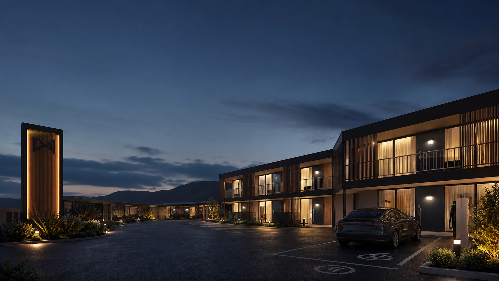 A transformed modern roadside motel glowing at blue hour